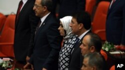 A group of ruling party lawmakers look on as newly elected legislators take their oaths during the new Turkish parliament’s opening session in Ankara, Turkey, June 23, 2015.