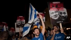 FILE - Israelis hold up banners during a demonstration in Tel Aviv against the emerging natural gas deal, Nov. 28, 2015.