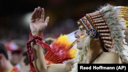 A Kansas City Chiefs fan does the "tomahawk chop" during the second half of an NFL football game in Kansas City, Mo., Monday, October 2, 2017