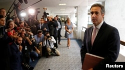 FILE - Michael Cohen, personal attorney for U.S. President Donald Trump, talks to reporters after meeting with Senate Intelligence Committee staff in Washington, Sept. 19, 2017.