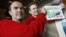 Peter Vesterbacka, Mighty Eagle, Chief Marketing Officer, left, and Henri Holm, Senior Vice President Of Rovio Asia, right, show the latest version of Angry Birds after the opening ceremony of the Shanghai office of Rovio, maker of popular game "Angry Bir