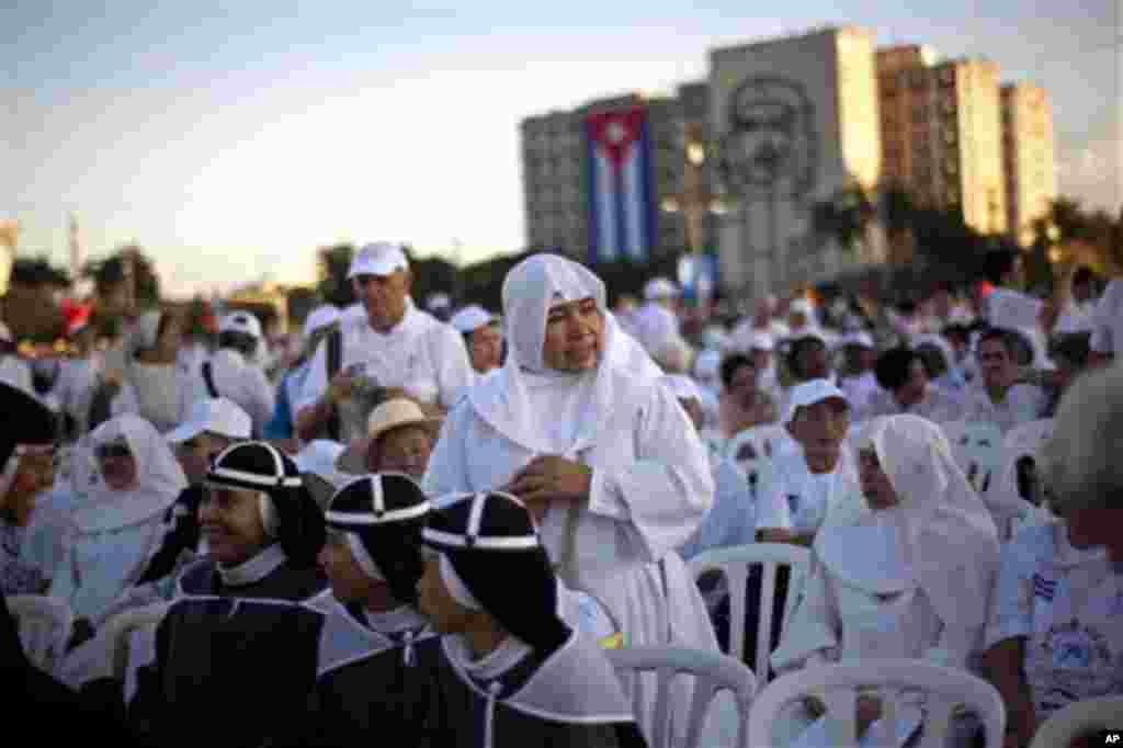 Nuns wait as worshippers gather in Revolution Square for the arrival of the Pope Benedict XVI to celebrate a Mass in Havana, Cuba, Wednesday, March 28, 2012. Pope Benedict XVI wraps up his visit to Cuba on Wednesday with an open-air Mass in the shrine of