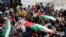 Palestinians carry the bodies of Amer Nassar, 17, and Naji Belbisi, 18, into a mosque during their funeral in the West Bank, April 4, 2013. 