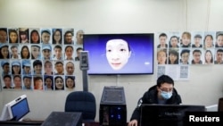 Software engineers work on a facial recognition system that identifies people when they wear a face mask at the development lab of the Chinese electronics manufacturer Hanwang (Hanvon) Technology in Beijing as the country is hit by an outbreak of the nove