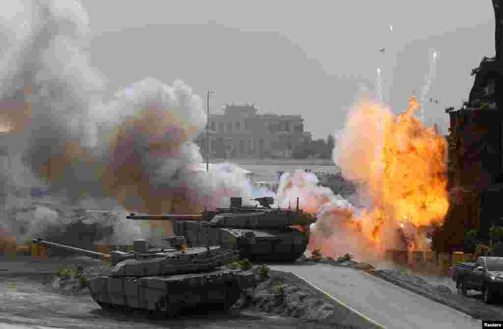 Flames and smoke are seen during a military show at the opening ceremony of the International Defence Exhibition and Conference (IDEX) in Abu Dhabi, United Arab Emirates.