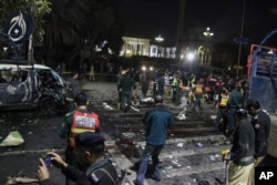 Police and security officers cordon off the area of a deadly bombing, in Lahore, Pakistan, Monday, Feb. 13, 2017.