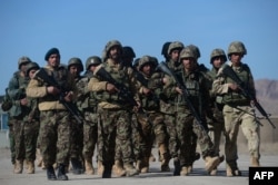 FILE - Afghan National Army soldiers march during training by NATO's Resolute Support Mission on the outskirts of Herat, Feb. 9, 2017.