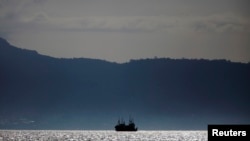 FILE - Chinese fishing trawlers anchor off the coast of Freetown, Nov. 18, 2012.