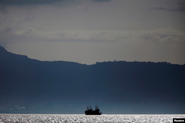 FILE - Chinese fishing trawlers anchor off the coast of Freetown, Sierra Leone, Nov. 18, 2012.