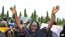 FILE—An unidentified mother cries out during a demonstration with others who have daughters among the kidnapped school girls of government secondary school Chibok, April 29, 2014, in Abuja, Nigeria