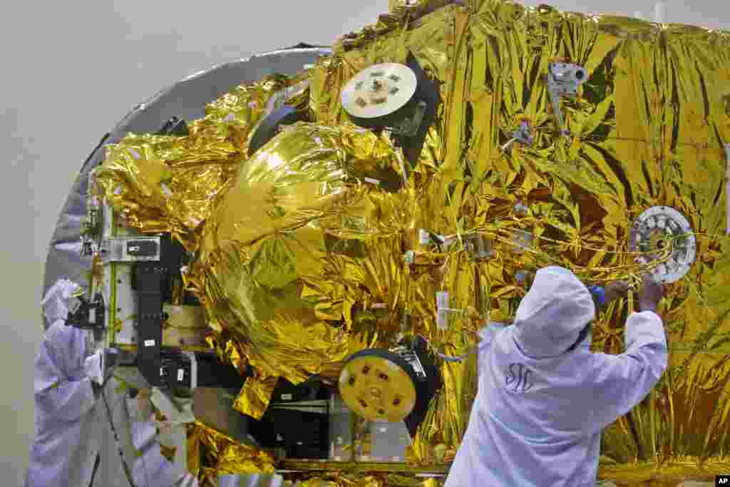 Indian engineers work on the Mars orbiter spacecraft at the satellite center of Indian Space Research Organization in Bangalore. India&rsquo;s ambitious US$71,096,000 Mars orbiter mission is scheduled to be launched by Polar Satellite Launch Vehicle between Oct. 21 and Nov. 19, 2013 from Sriharikota in south India, project director Arunan. S said.