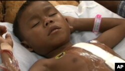 Eight-year-old Nan Kini remains in the hospital, after his heart was repaired recently at a hospital in Siem Reap. 