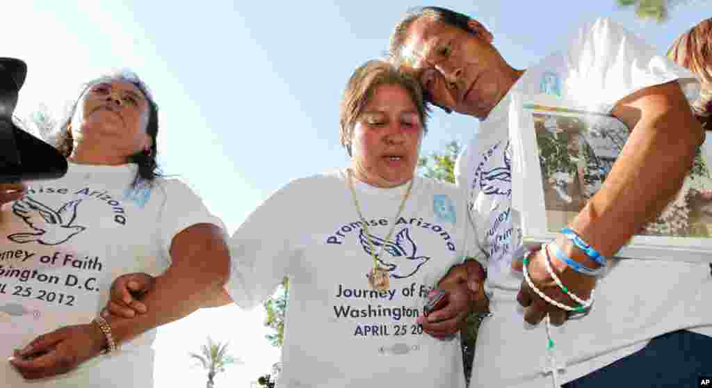 Members of the nonprofit Promise Arizona react to the United States Supreme Court decision regarding Arizona&#39;s controversial immigration law, SB1070, as the ruling came down at the Arizona Capitol Monday, June 25, 2012, in Phoenix.