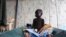 A South Sudanese child suffering from cholera sits on a bed in Juba Teaching Hospital, May 27, 2014. China has pledged $33 million to renovate the hospital. 