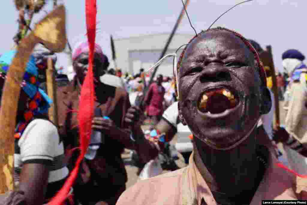 A South Sudanese man beams during a celebration to mark the resumption, after a 16-month break, of oil production at Paloch oil field on Sunday, May 5, 2013. 