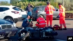 Ambulance personnel tend to a man lying on the ground, later identified as actor George Clooney, after being involved in a scooter accident in the near Olbia, on the Sardinia island, Italy, July 10, 2018. 