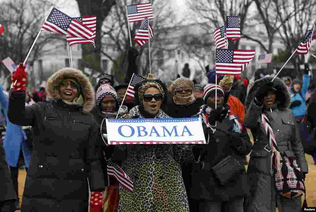 People cheer on the National Mall during the ceremonial swearing-in ceremonies on the West front of the U.S. Capitol in Washington January 21, 2013