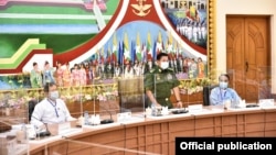 Myanmar army chief Senior General Min Aung Hlaing (center) and U Than Htay (left), chairman of the military-backed Union Solidarity and Development Party, attend a meeting between the military chief and leaders of 34 political parties on Aug. 14 in Naypyi