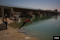 The new bridge over the Euphrates River was rebuilt and now links the two sides of Raqqa, Syria, Aug. 25, 2019. (Yan Boechat/VOA)