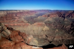 FILE - In this Oct. 5, 2013, file photo, the Grand Canyon National Park is covered in the morning sunlight as seen from a helicopter near Tusayan, Arizona, Jan. 19, 2018.