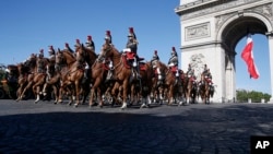 French Republican Guards ride their horses past the Arc de Triomphe in Paris, July 14, 2017. The annual Bastille Day parade is being opened by American troops with President Donald Trump as the guest of honor to commemorate the 100th anniversary of the United States entering World War I.