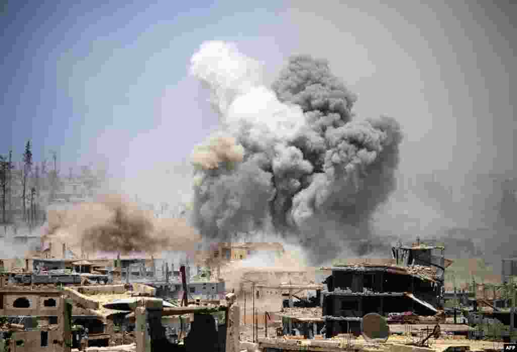 Smoke rises from buildings following a reported airstrike on a rebel-held area in the southern Syrian city of Daraa.