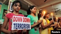 FILE - Students in Agartala, India, show solidarity with victims of a terrorist attack on a Bangladeshi café in early July. On Tuesday, Indian and U.S. officials announced plans for greater cooperation in combatting terrorism.