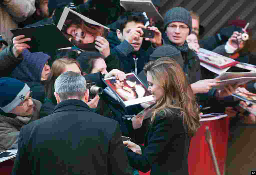 Angelina Jolie signs autographs prior to the press conference for her film "In The Land Of Blood And Honey" in Berlin, Germany, February 11, 2012. (AP)