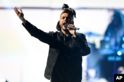 The Weeknd performs at Day 2 of the 2015 iHeartRadio Music Festival at the MGM Grand Garden Arena, Sept. 19, 2015, in Las Vegas, Nevada.