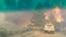 FILE - Flames rise from a treeline near an emergency vehicle during efforts to contain the Spring Fire in Costilla County, Colorado, June 27, 2018. 
