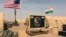 FILE - In this photo taken April 16, 2018, a U.S. and Niger flag are raised side by side at the base camp for air forces and other personnel supporting the construction of Niger Air Base 201 in Agadez, Niger. 