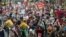 Demonstrators hold placards as they march during a protest against the Conservative Government and it's austerity policies in London, June 20, 2015. 