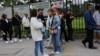 People who had an appointment scheduled for the visa process to the United States and were canceled, wait outside the United States embassy for rescheduling information, in Bogota, Colombia, Jan. 27, 2025. 