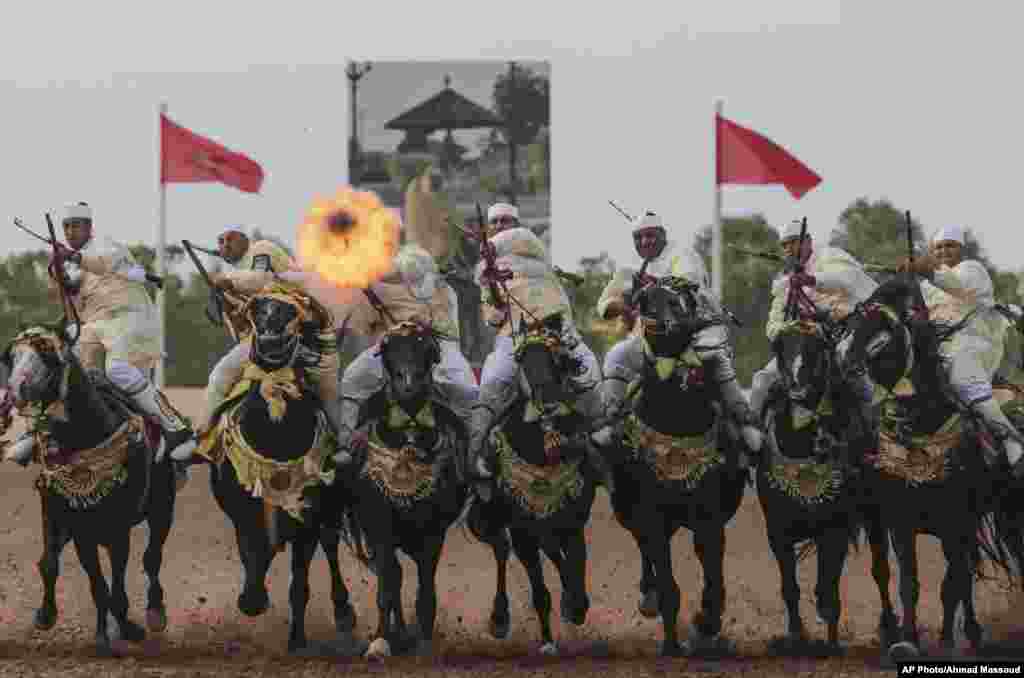 A troupe charges and fire their rifles loaded with gunpowder during a national competition for Tabourida, a traditional horse riding show also known as Fantasia, in El Jadida, Morocco, Oct. 18, 2017.