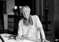 FILE - Architect Frank Lloyd Wright in his studio at his home, Talisien, in Spring Green, Wisconsin, Aug. 16, 1938.