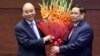 Vietnamese newly elected President Nguyen Xuan Phuc, left, and newly elected Prime Minister Pham Minh Chinh pose for a photo in the National Assembly in Hanoi, Vietnam on Monday, April 5, 2021. (Hoang Thong Nhat/VNA via AP)