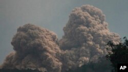 Mount Rokatenda is seen spewing volcanic material on Palue island, Indonesia, August 11, 2013.