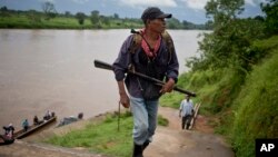 FILE - A Miskito man arrives after taking part in a defense patrol, in La Esperanza, Nicaragua, Sept. 19, 2015. Miskito men who are resisting the arrival of settlers patrol the humid terrain.