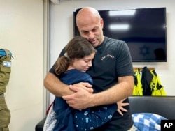 هیلا روتم شوشانی ۱۳ ساله پس از آزادی از اسارت حماس دایی خود یاییر روتم را بغل کرده است - ۵ آذر ۱۴۰۲