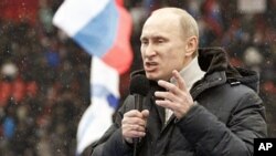 Presidential candidate and Russia's current Prime Minister Vladimir Putin delivers a speech during a rally in Moscow to support his candidature in the upcoming presidential election, February 23, 2012