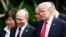 U.S. President Donald Trump, right, and Russia's President Vladimir Putin, center, talk during a group photo session at the APEC Summit in Danang, Vietnam, Nov. 11, 2017.