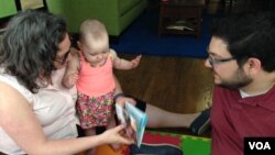 Rob and Jessica Lott enjoy spending time with their 11-month old daughter Shulie, June 10, 2016. (J. Taboh/VOA)