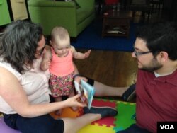 Rob and Jessica Lott enjoy spending time with their 11-month old daughter Shulie, June 10, 2016. (J. Taboh/VOA)