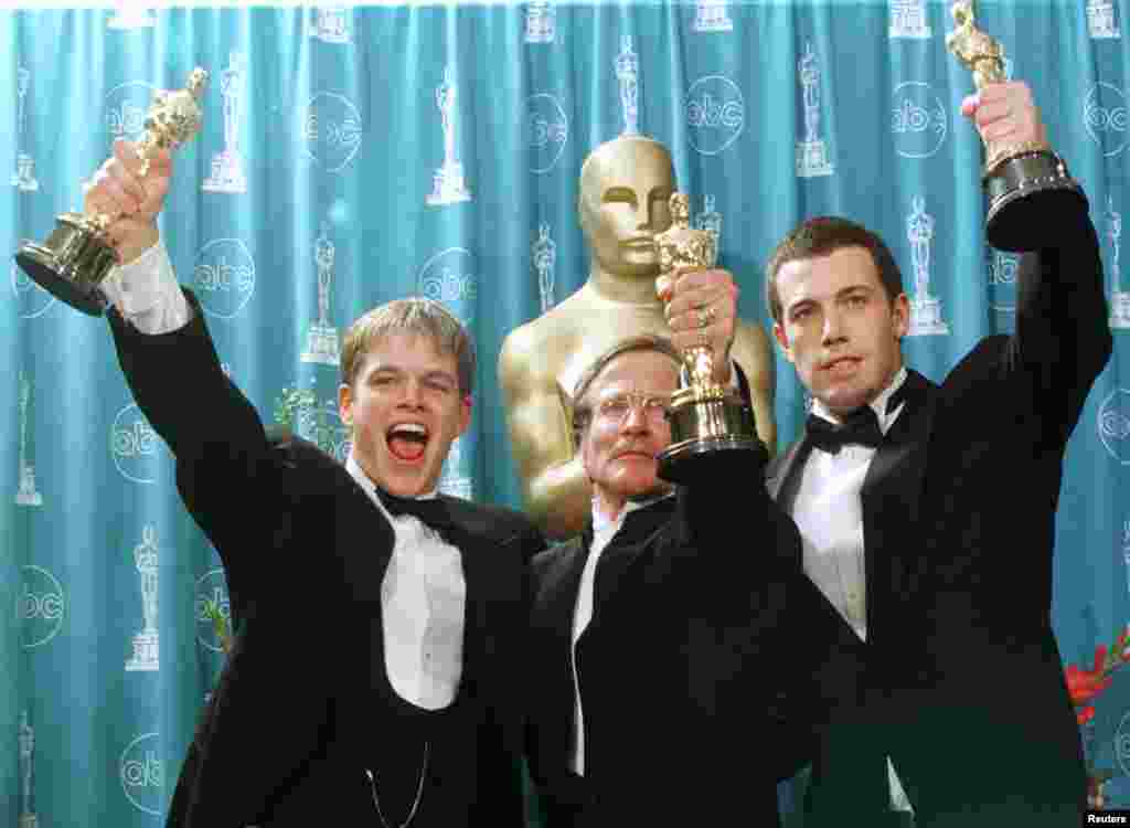 Oscar winners (left to right) Matt Damon, Robin Williams and Ben Affleck hold their Oscars for their work on the film &quot;Good Will Hunting&quot; at the 70th Annual Academy Awards, March 23, 1998, in Los Angeles. Damon and Affleck won for Best Screenplay Written Directly for the Screen and Williams won for Best Supporting Actor.