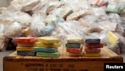 FILE - Cocaine from Britain's largest ever cocaine seizure is seen on display in London, Aug. 3, 2011. 