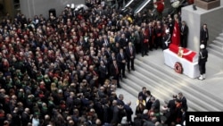 People attend the funeral ceremony of prosecutor Mehmet Selim Kiraz at the Justice Palace in Istanbul, Turkey, April 1, 2015. 