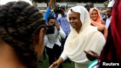 FILE - Sudan's member of sovereign council Aisha Musa greets players before Sudan's first women's league soccer match at the Khartoum stadium, Khartoum, Sudan Sept. 30, 2019.