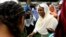 FILE - Sudan's member of sovereign council Aisha Musa greets players before Sudan's first women's league soccer match at the Khartoum stadium, Khartoum, Sudan Sept. 30, 2019.