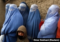 Perempuan Afghanistan berbaris untuk menerima bantuan bantuan musim dingin yang disumbangkan oleh Program Pangan Dunia (WFP) di sebuah kamp pengungsi di Kabul 13 Januari 2015. (Foto: REUTERS/Omar Sobhani)