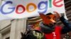 Activists from anti-globalization organisation Attac stage a protest at Google's Paris headquarters to criticize the company's tax evasion policies, in Paris, Jan. 31, 2019.